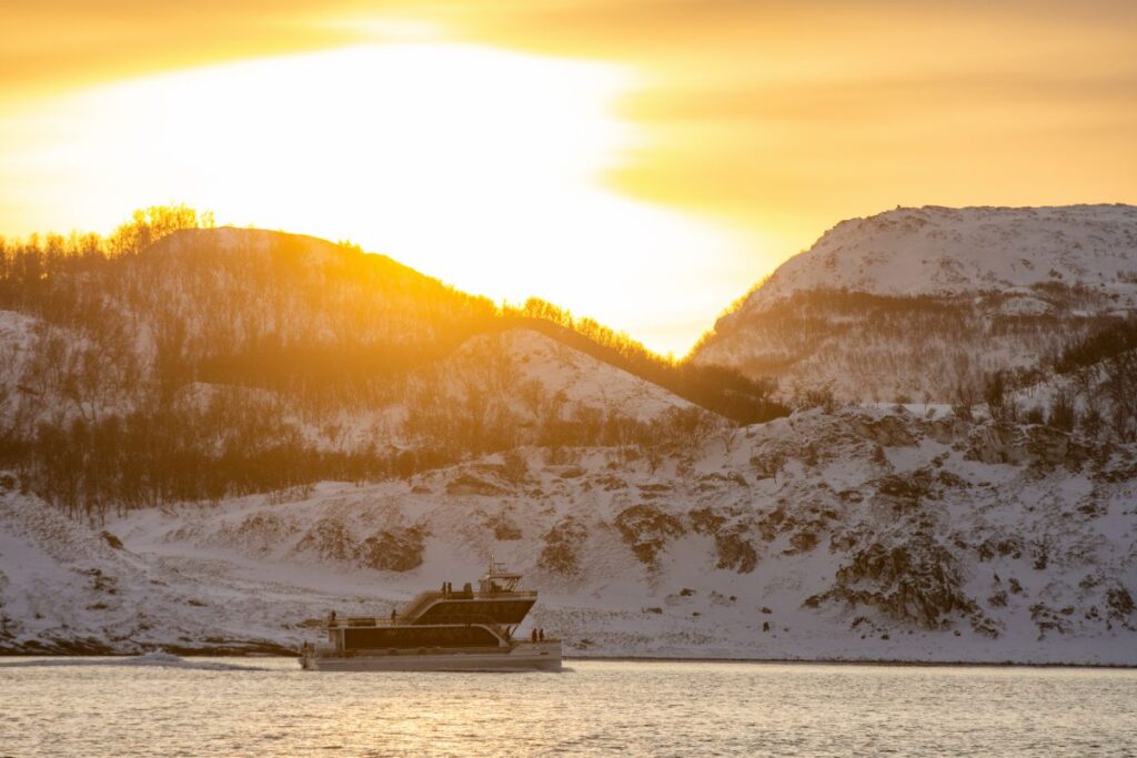 Brim explorer fjord cruise in the setting sun in january in Tromsø